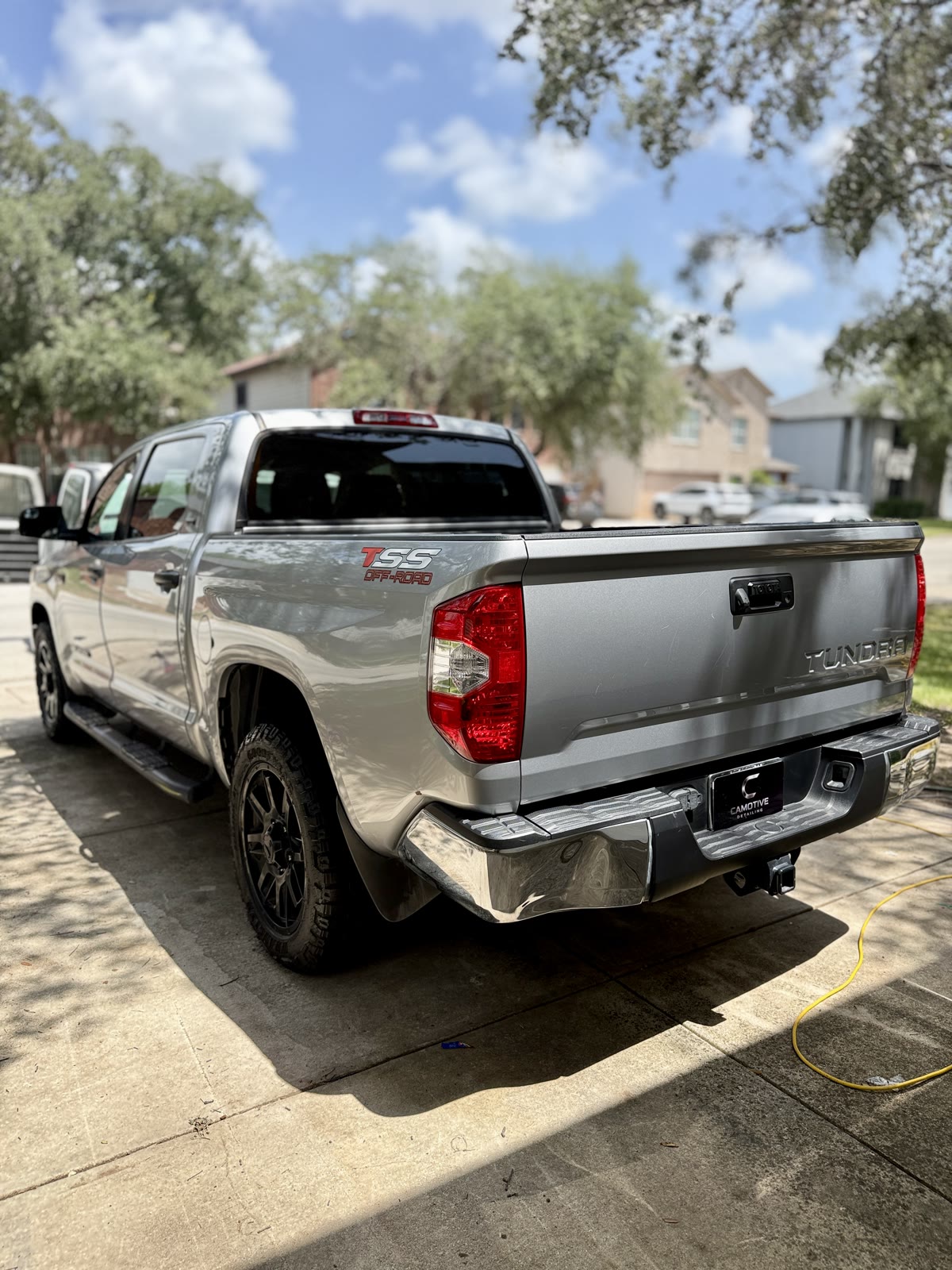 Reflections along the bed and tailgate of a silver Toyota Tundra